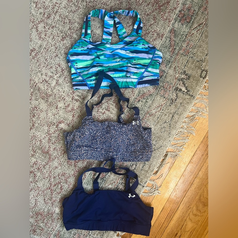 Three sports bras for sale - top one Lululemon and bottom two under armour